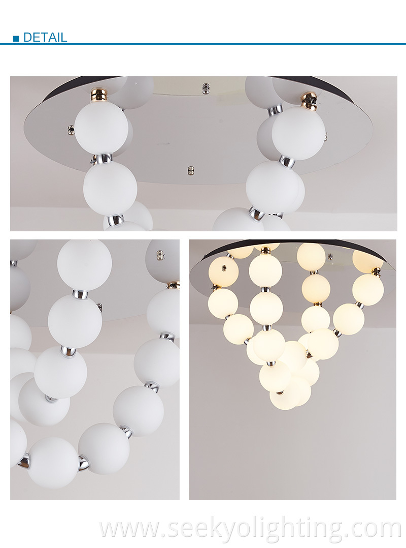 It features a series of opal glass balls that are suspended from a chrome-finished ceiling plate, creating a beautiful and eye-catching design.